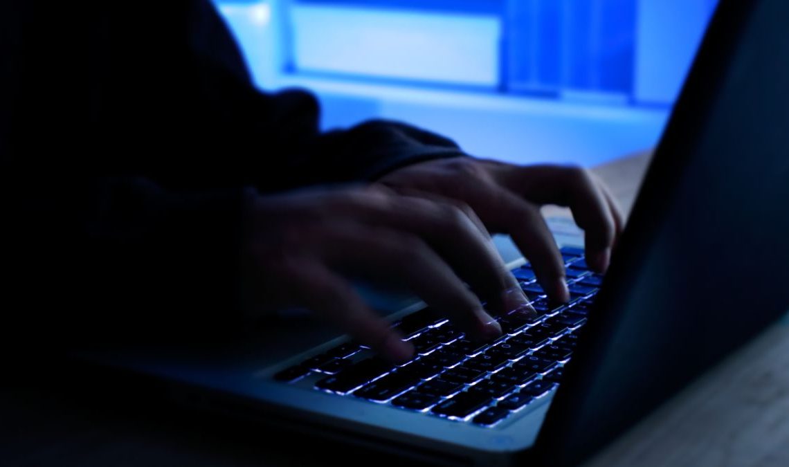 Hacker hacking away on a keyboard.