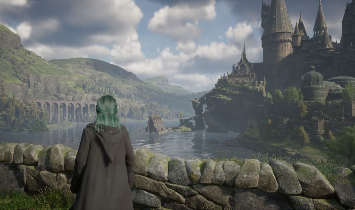 Hogwarts Legacy release times - character is looking across a lake towards Hogwarts.