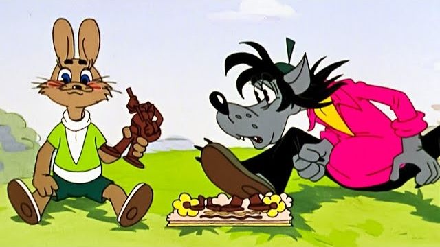 The hare and wolf from Soviet cartoon Nu, Pogodi! sit side-by-side on the grass.