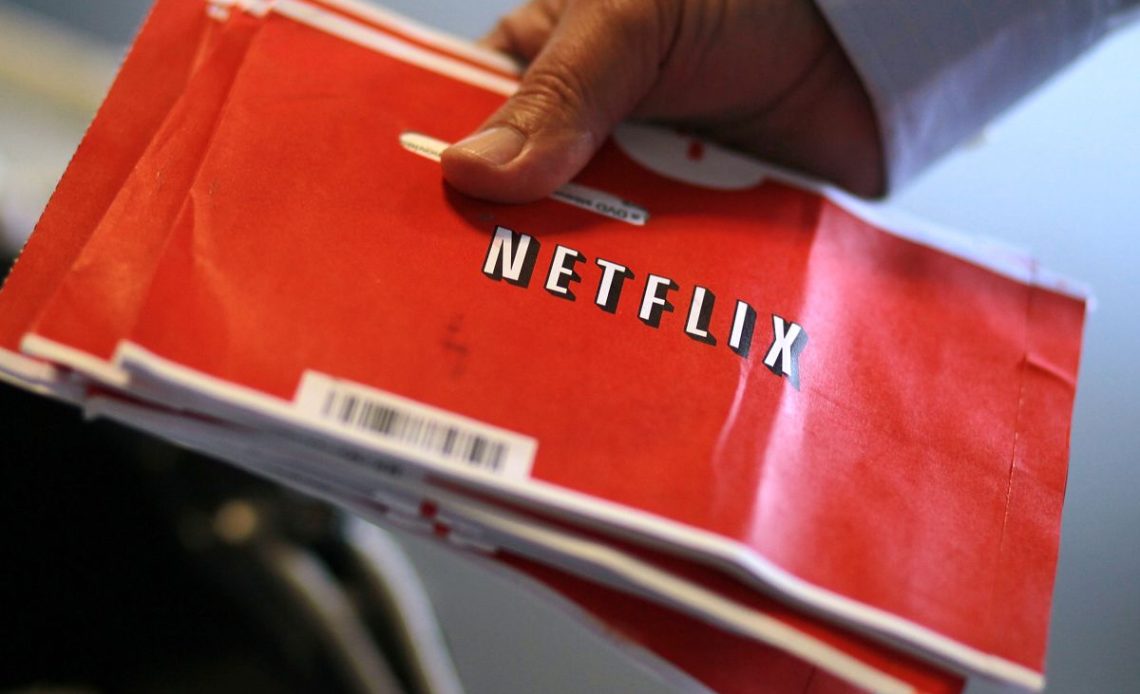 A U.S. Postal worker holds a stack of Netflix envelopes at the U.S. Post Office sort facility on October 24, 2011 in San Francisco, California.