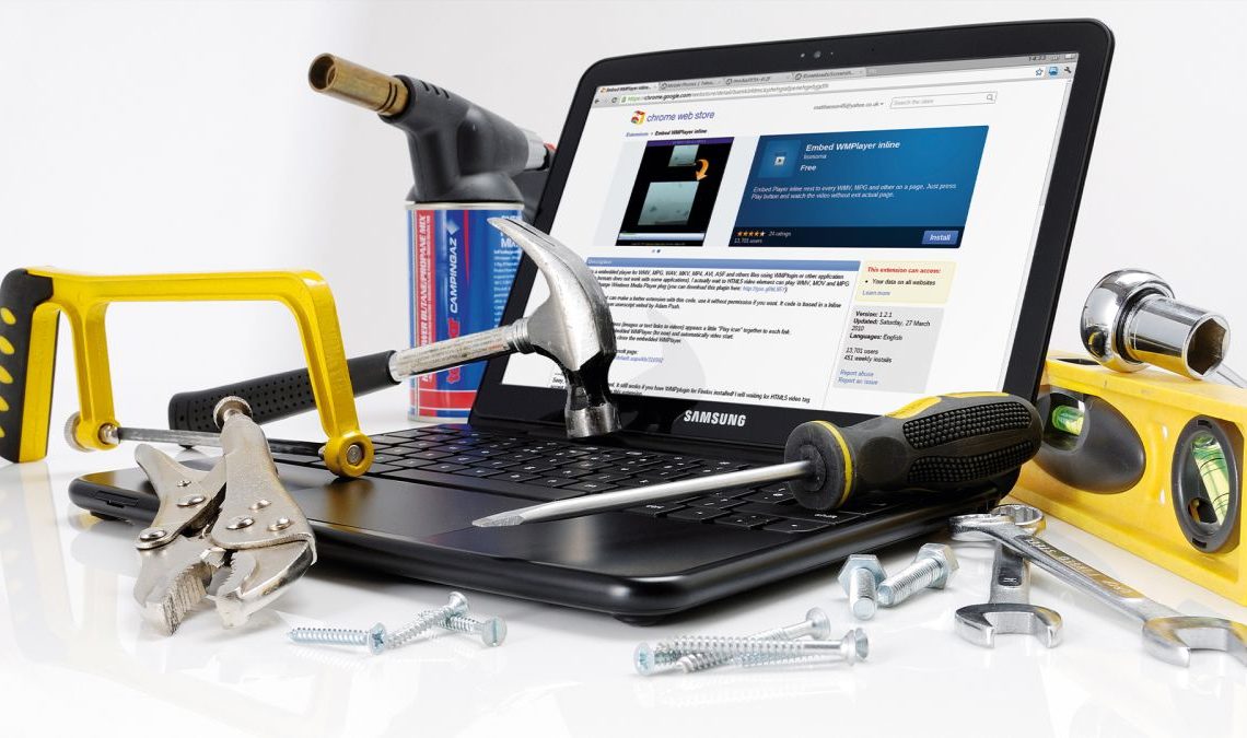 A laptop covered in tools and equipment